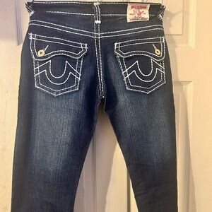 Size 31 Dark blue True Religion jeans with white stitching along the edges.